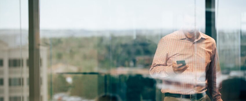 Man smiling at iphone