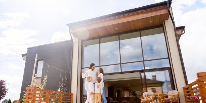 Family in front of new house