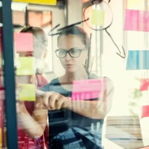 two engineers reviewing sticky notes