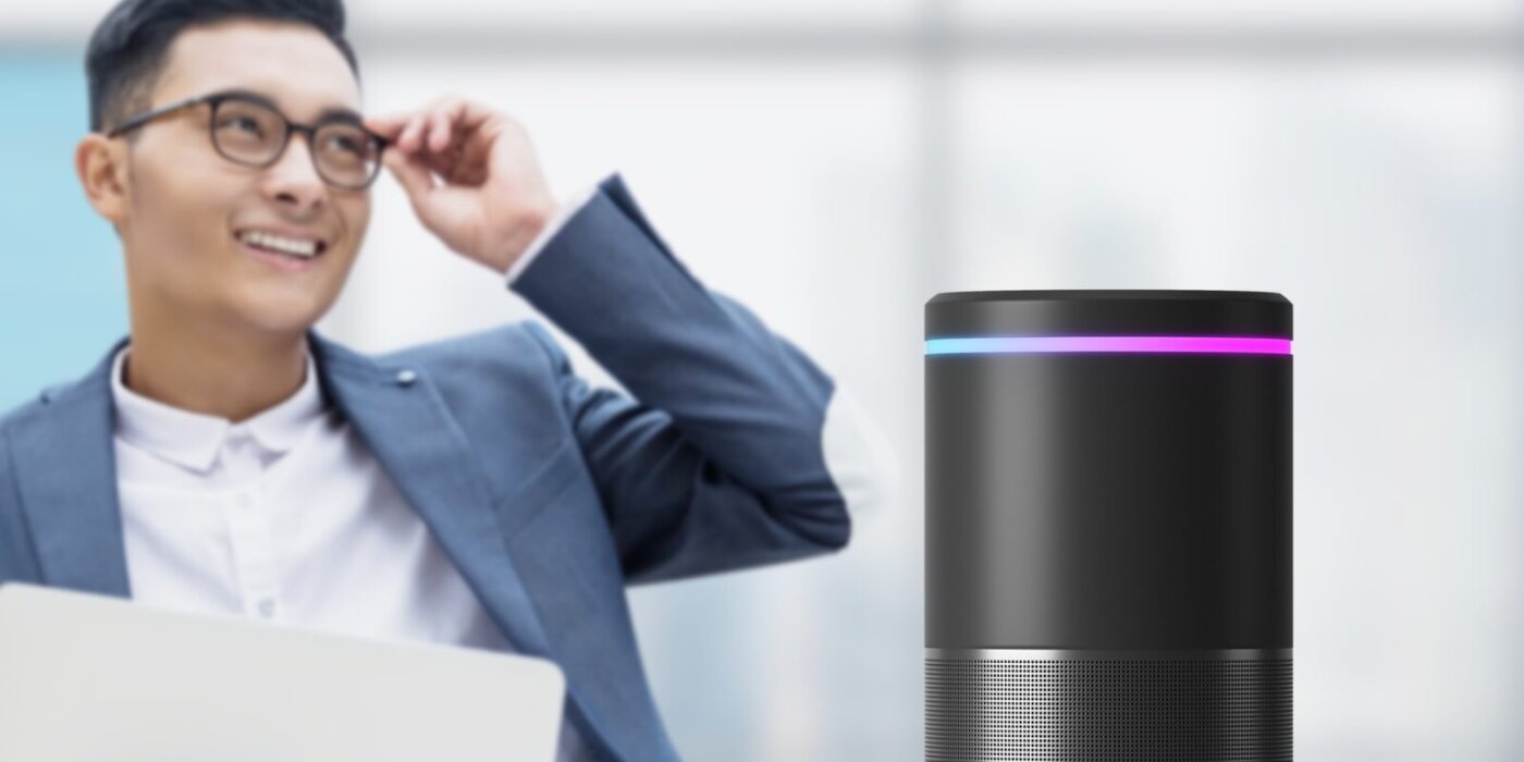 Man standing behing a smart speaker