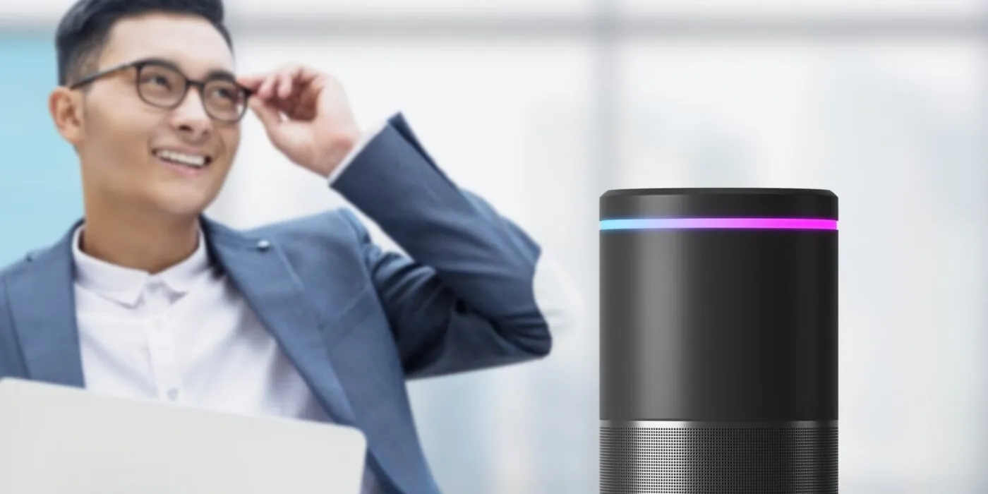 Man standing behing a smart speaker