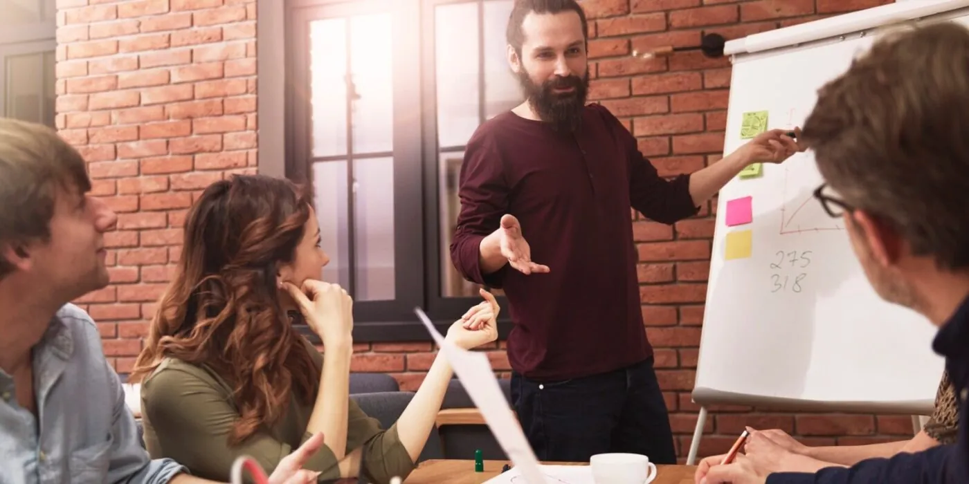 Man presenting ideas to coworkers