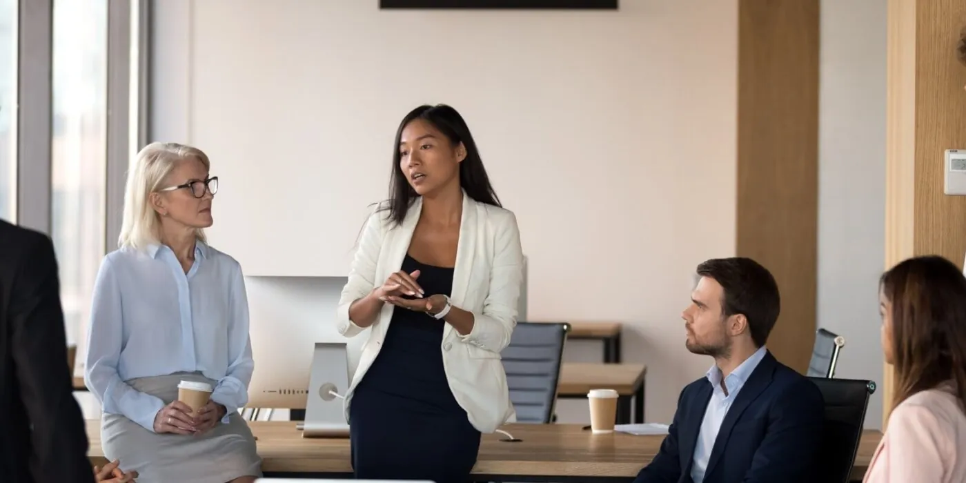 Woman speaking to her coworkers