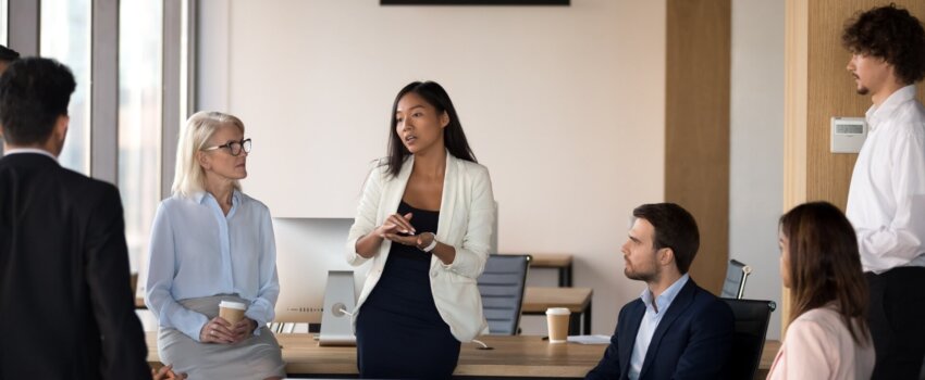 Woman speaking to her coworkers