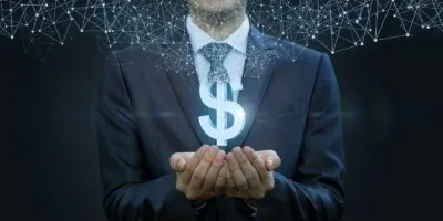 in the hands of a businessman appears the dollar
