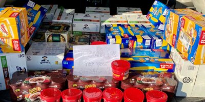 Food donations with sign that rads "Thank you for your donations!"