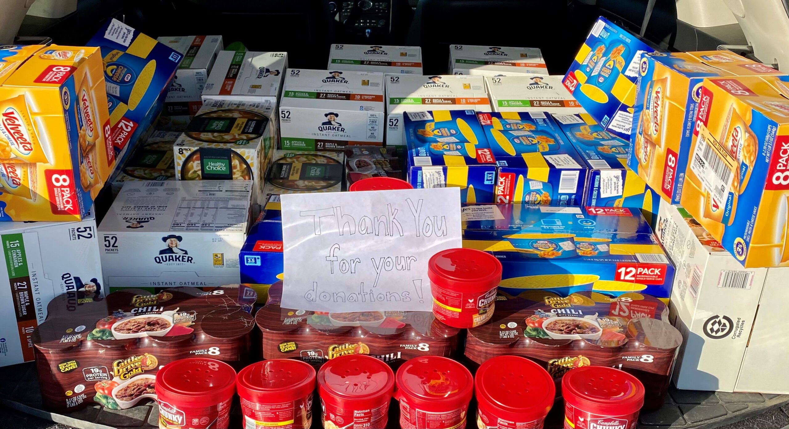 Food donations with sign that rads "Thank you for your donations!"