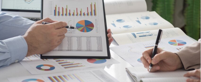 Image of a employee presenting data to another employee