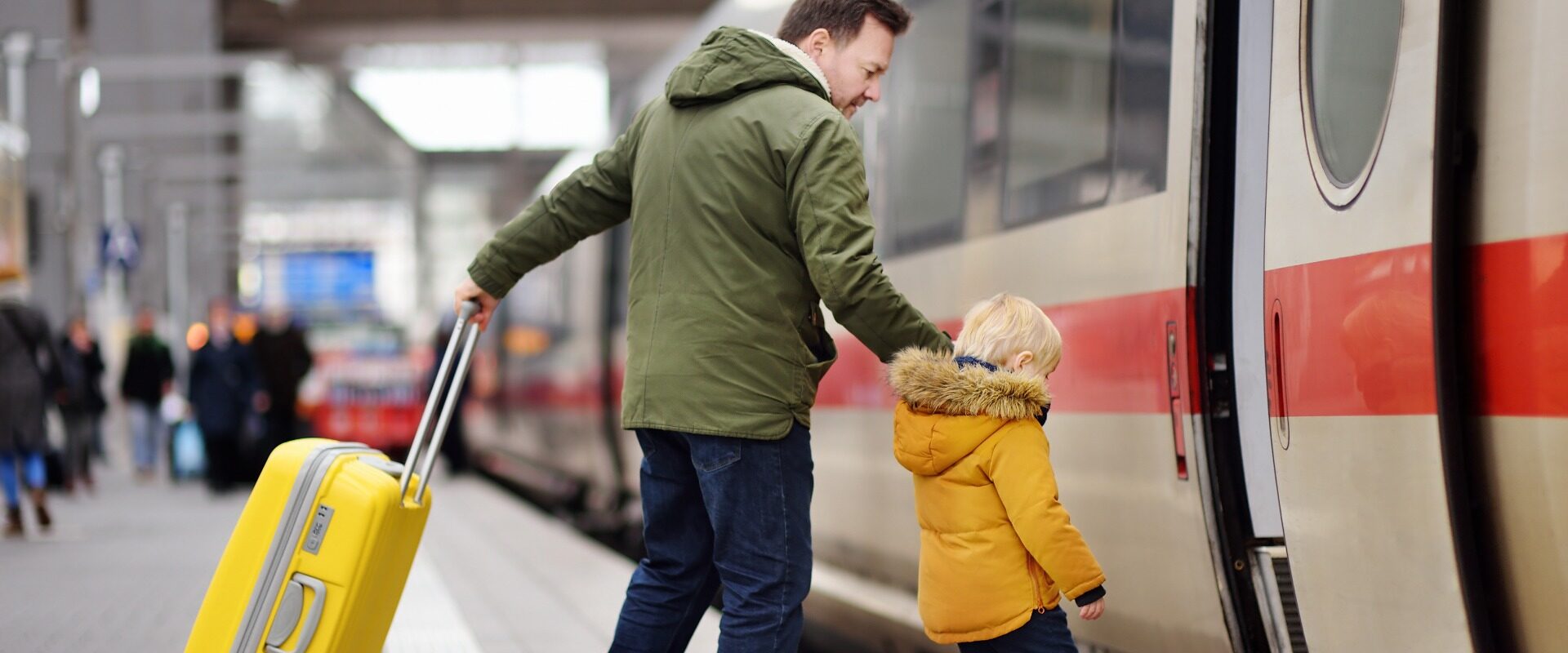 Father and young son boarding train