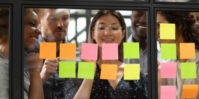 Woman behind sticky notes on glass