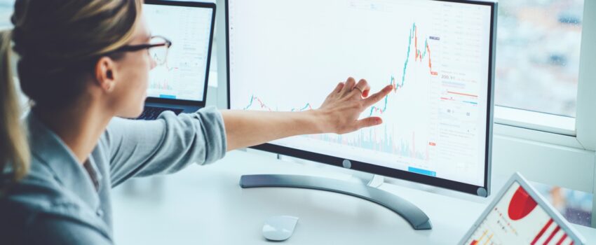 Business woman studying financial market on computer screen