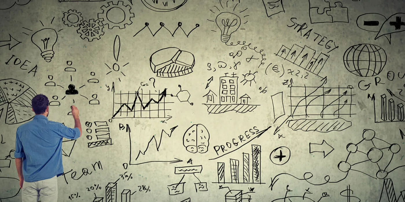 An employee brainstorming on a white board