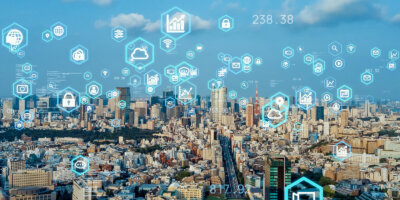 Technology related icons floating above a city