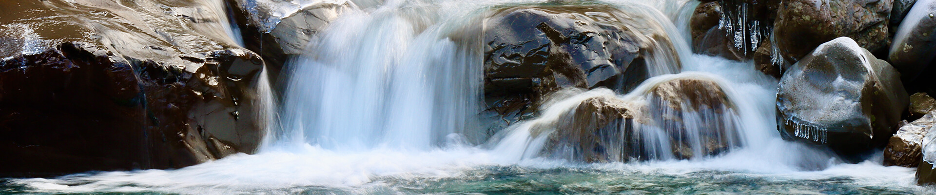 water falling off of a rock