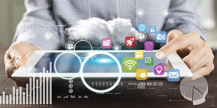 Icons of marketing channels as well as transparent graphs are overlaid on an image of a person holding a tablet, indicating marketing analysis.