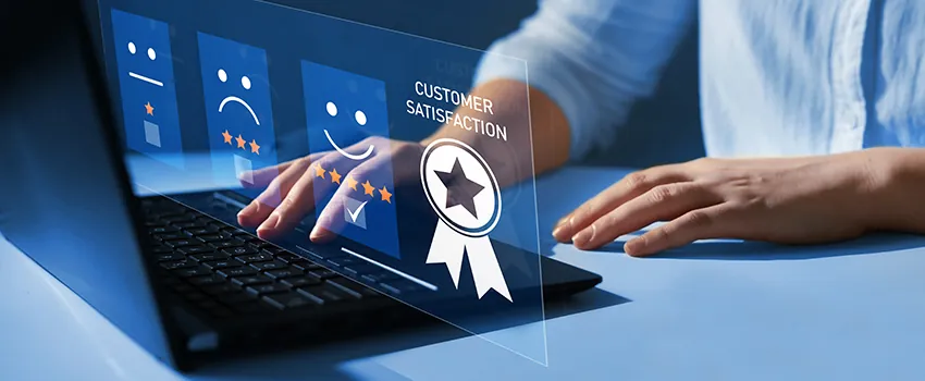 A man's hand types on a laptop while the icons illustrating CX metrics and customer satisfaction hover over top.