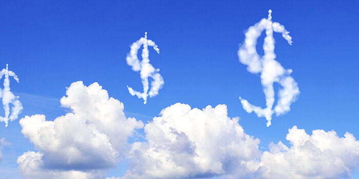An image of clouds against a blue sky. several of the clouds are shaped like dollar signs.