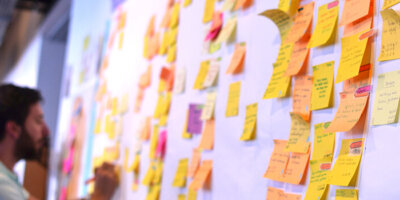 An agile software developer is updating Kanban board