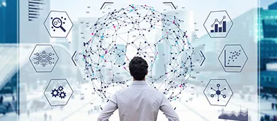 A man stands with his back to the camera, looking at a holographic projection of a network, with several icons representing AI and data called out on the sides.