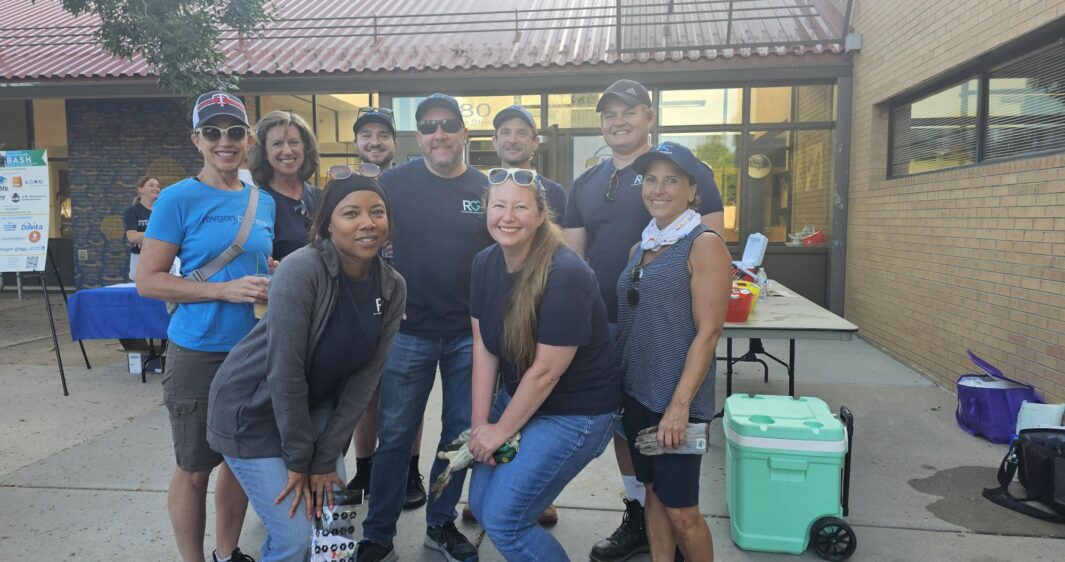 RevGen volunteers pose at the DPS Foundation's Back to Class Bash after cleaning the playground and school garden.