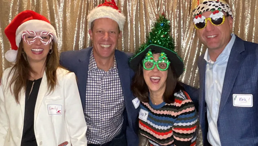 Emily Sims, Jason Hansen, Lisa Walvoord, and Kirk Mielenz pose with props during the RevGen Holiday Party
