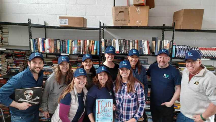 RevGeners pose at Book Give during the RevGen 15th Anniversary service event.