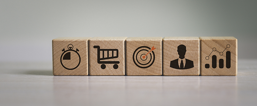Wooden blocks with various icons depicting the customer journey and customer experience metrics