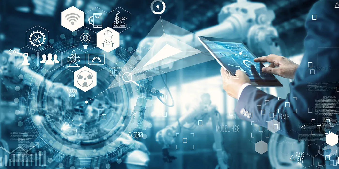 A man on a tablet reviews the predictive maintenance data that the smart factory he is standing in is displaying