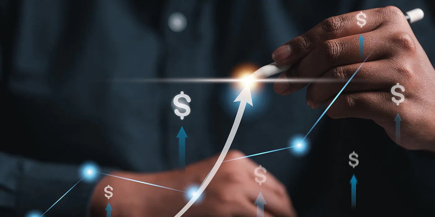 A man draws a revenue trend line over some $ points on a graph